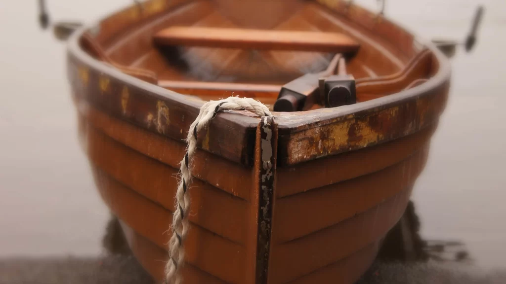 wooden boat, rope, oar, weathered, calm water