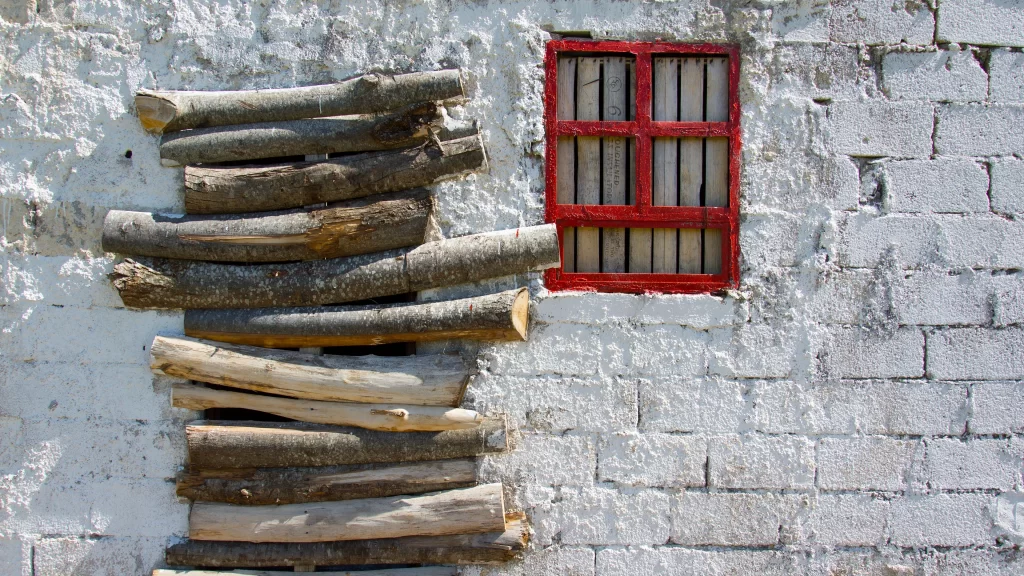 wooden logs white wall red window rustic