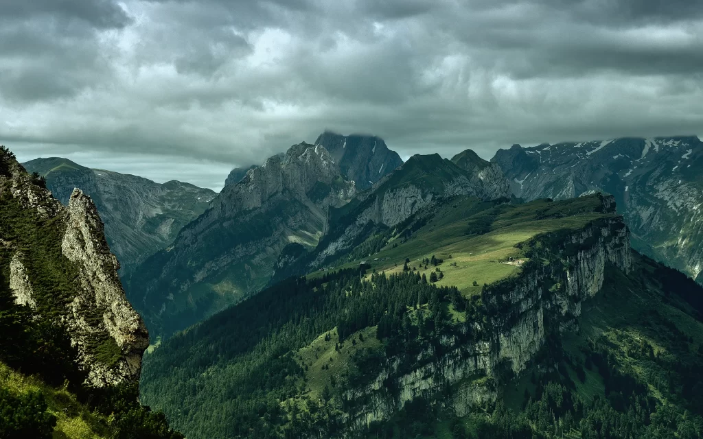 Mountainous Terrain Cloudy Sky Peaks Forested Slopes Majestic Landscape