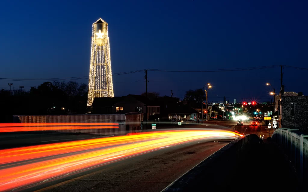 Nighttime Cityscape Illuminated Tower Traffic Lights Street Lights