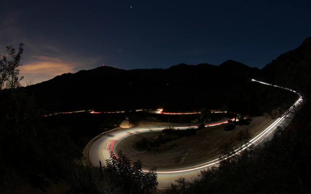 Nighttime Mountain Road Stars Light Trails Scenic
