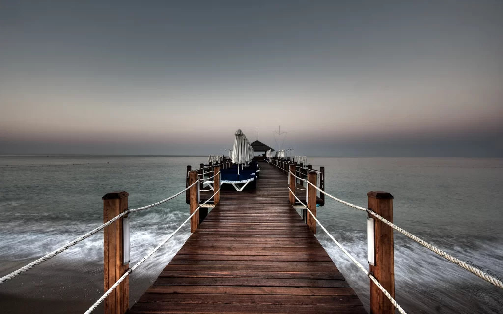 Pier Wooden Ocean Waves Umbrellas Chairs