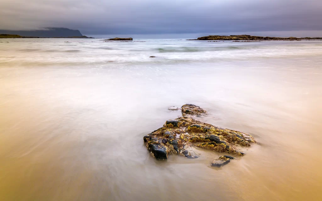 Rocky Shoreline Ocean Waves Cloudy Sky Sandy Beach