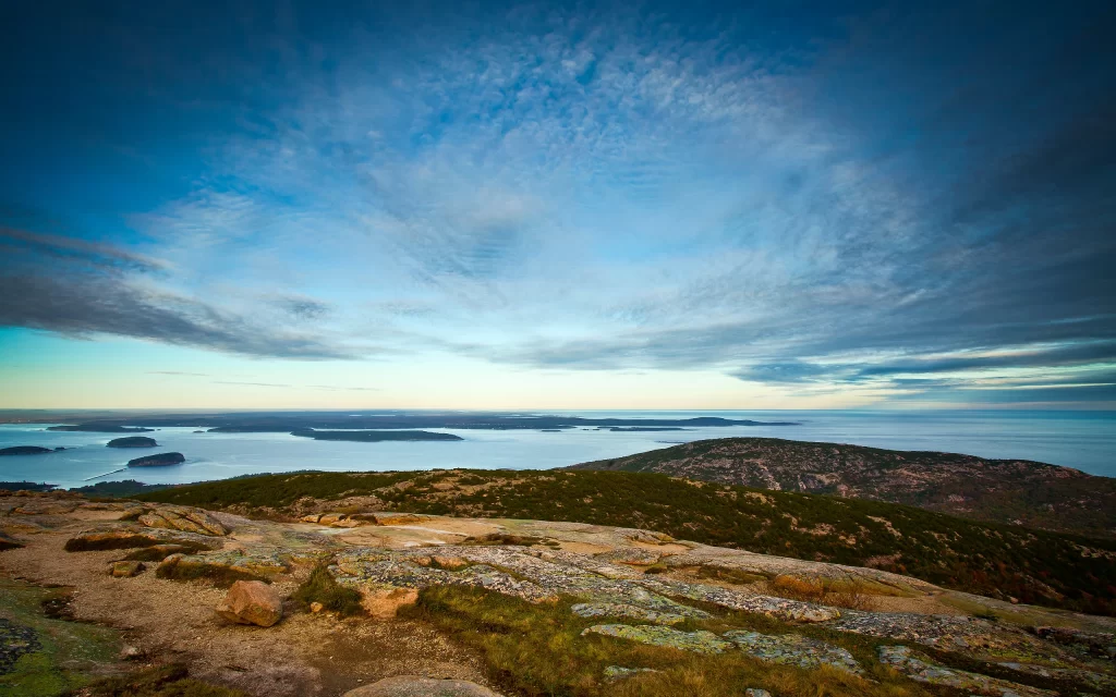 Scenic View Rocky Terrain Ocean Islands Cloudy Sky