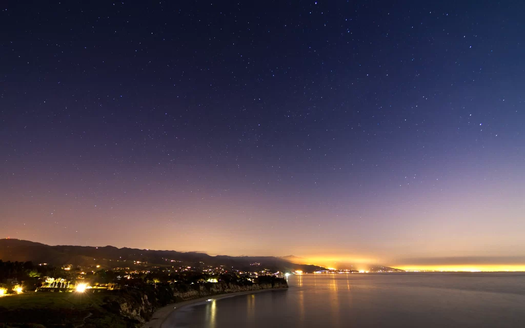 Starry Sky Coastal Cityscape Night Lights Ocean Horizon