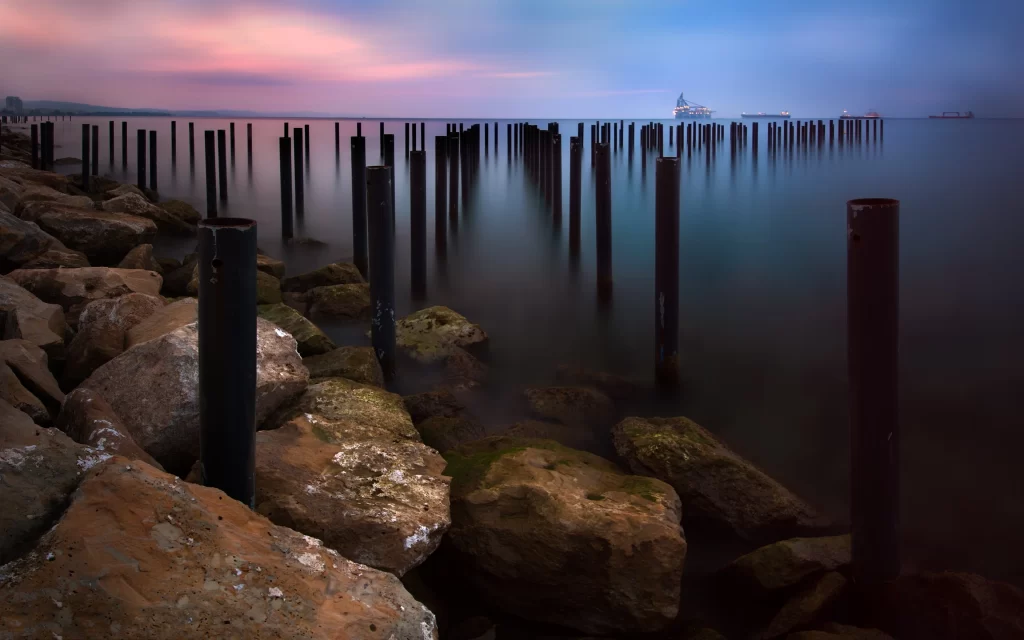 Twilight Ocean Rocks Poles Reflections